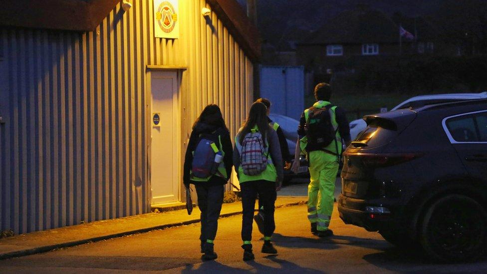 Hikers in the dark wearing high visibility jackets