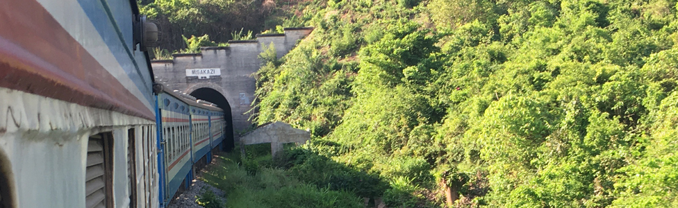 A Tazara train travelling from Tanzania to Zambia emerging from a tunnel