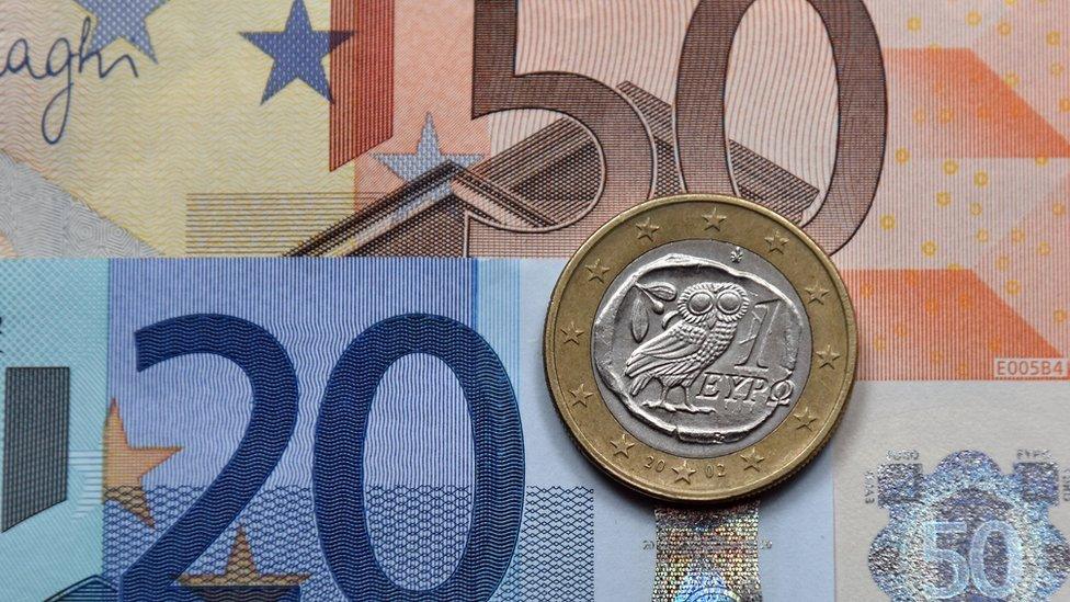 A Greek one Euro coin placed on Euro currency notes