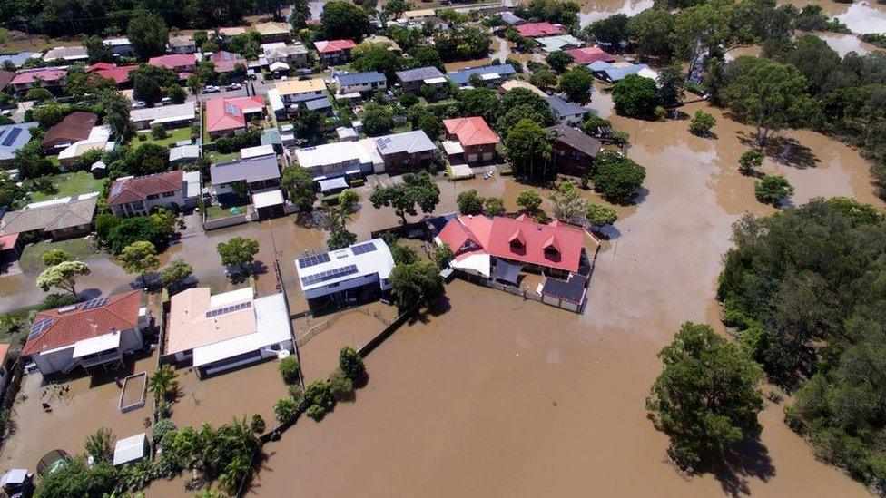 In the foreground the suburbs of Corinda and Oxley are seen flooded on March 1, 2022 in Brisbane, Australia.