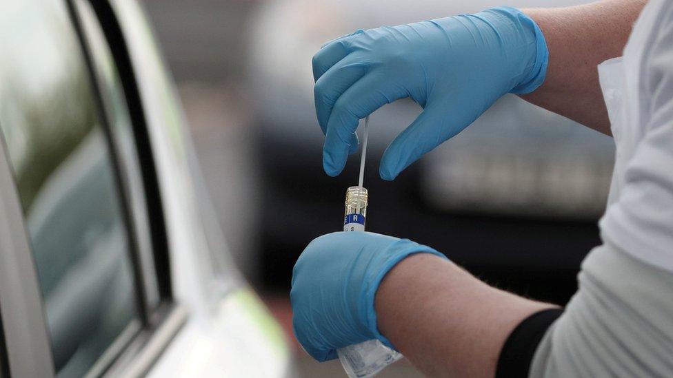 Covid-19 test swab being put in test tube