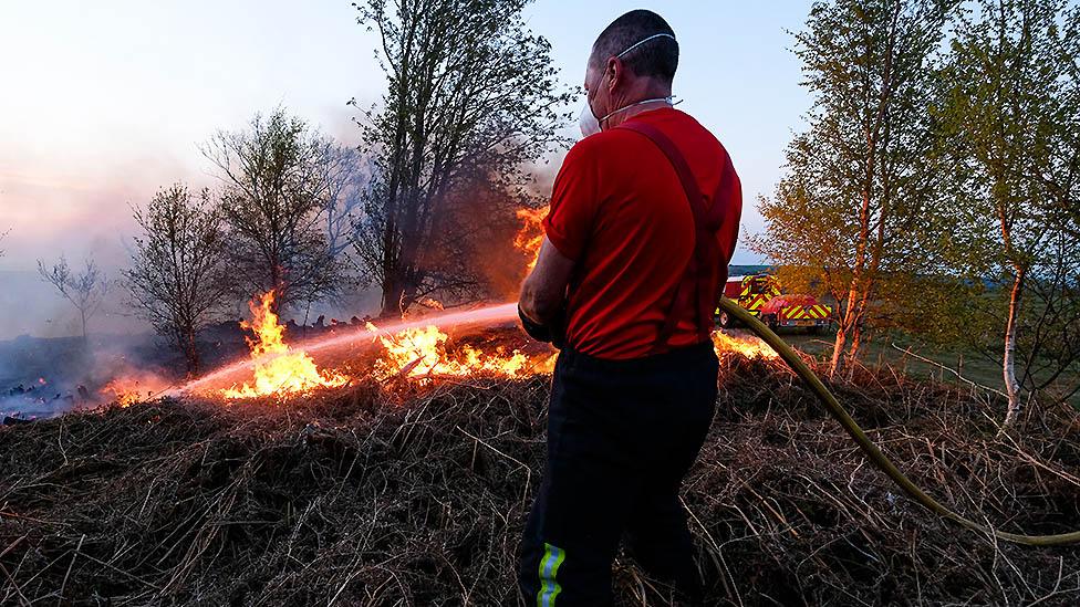 Fire fighter battles heath fire