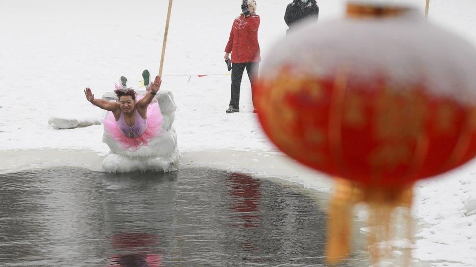 Woman jumps into ice pool