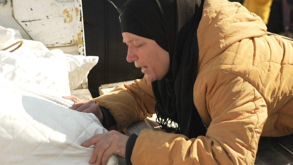 Aysha Moarri says farewell to her daughter, Shirin, at the Bab al-Hawa border crossing between Turkey and Syria