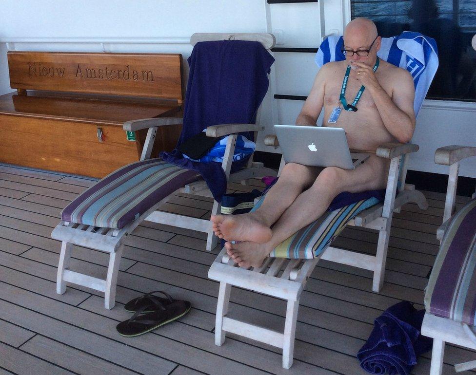 Mark Haskell Smith working on his laptop on a cruise ship