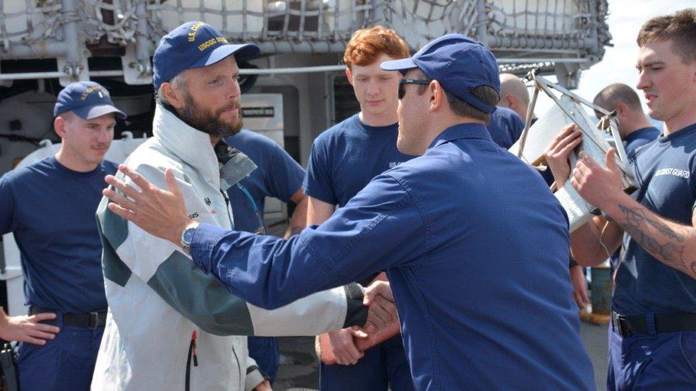 Niall Iain Macdonald, left, thanking US Coast Guard officers