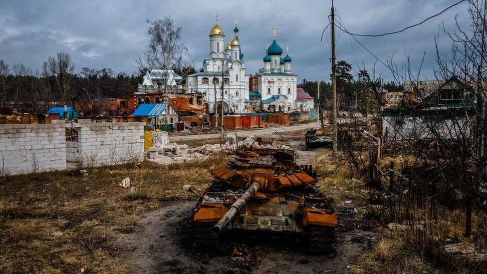 A destroyed Russian tank near a church in the city of Sviatohirsk, Donetsk