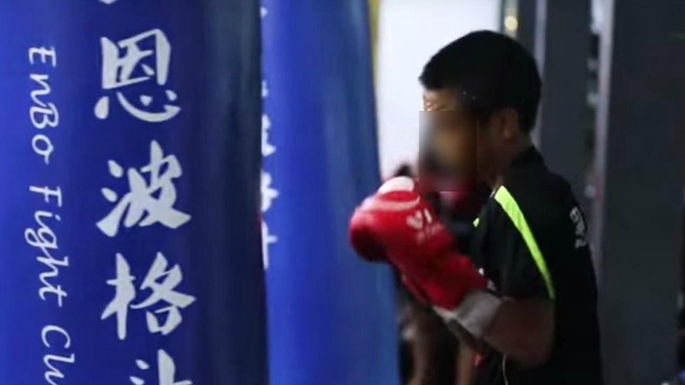 Child training with boxing bag at Enbo Fight Club