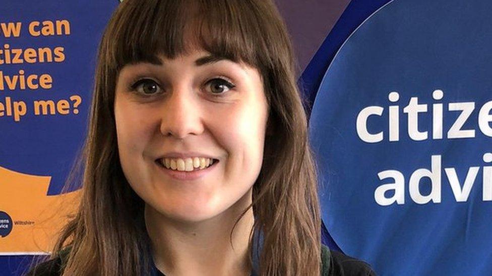 A women standing in front of a sign for citizens advice