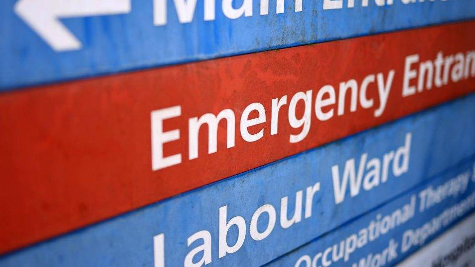 Hospital sign saying "Emergency Entrance" and "Labour Ward"