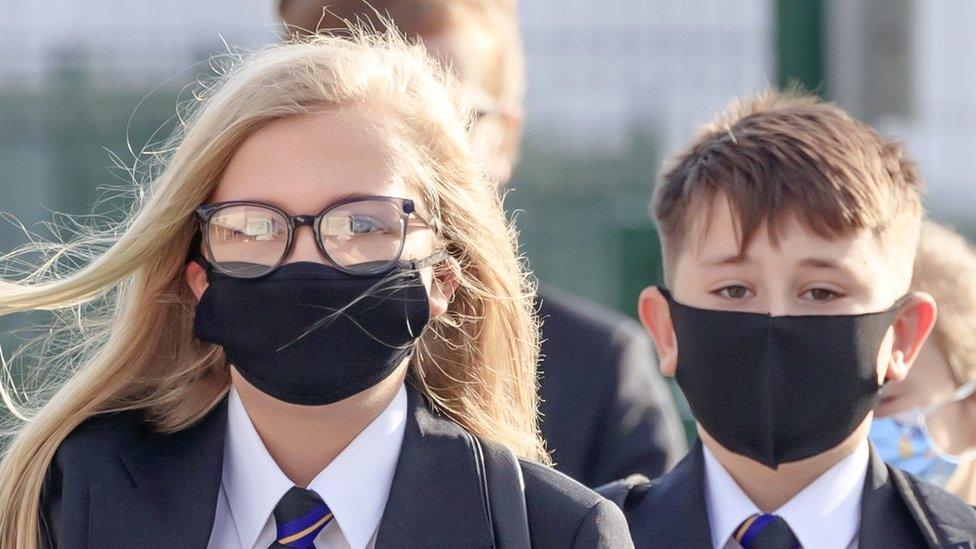 Pupils wear protective face masks