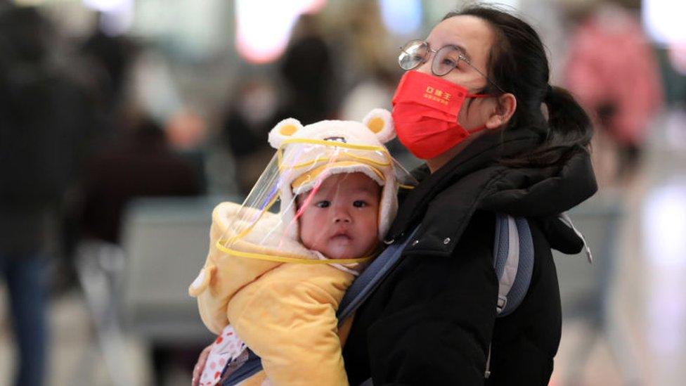 A woman holds a baby at Shijiazhuang Railway Station on the first day of 2023 China's Spring Festival travel rush on January 7, 2023 in Shijiazhuang, Hebei Province of China. The 40-day Spring Festival travel rush officially starts on January 7.