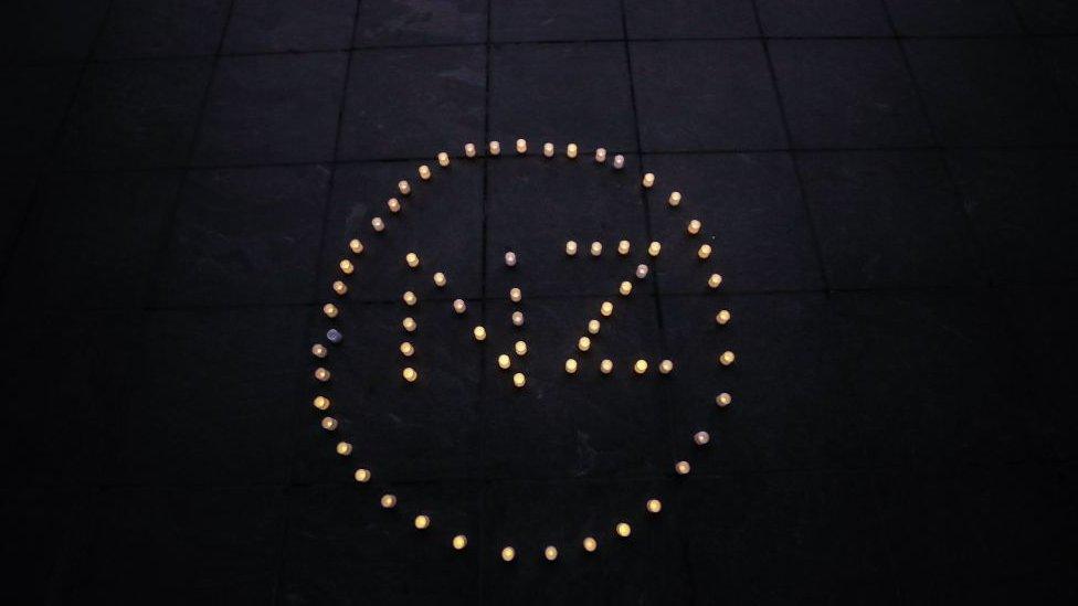 "NZ" spelled out in candles on floor