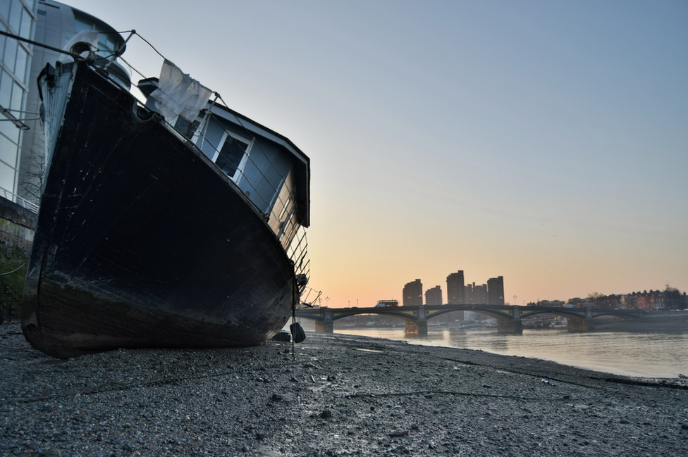 A large ship in front of a London skyline