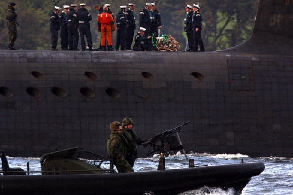 A trident submarine makes it's way out from Faslane Naval base