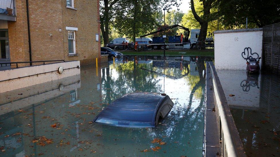 A car is submerged after a water supply pipe burst in the Hackney district of London, 3 October 2018