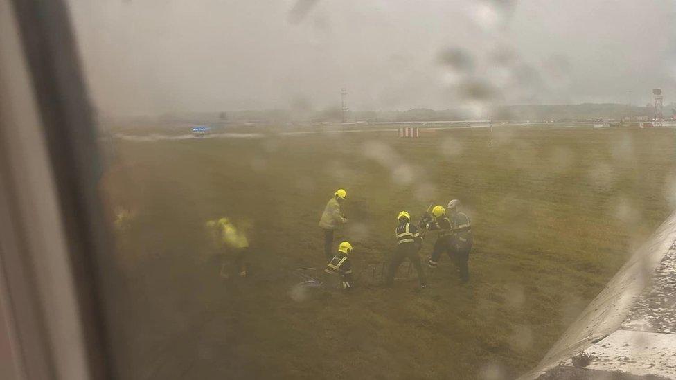 Firefighters seen through the plane's window