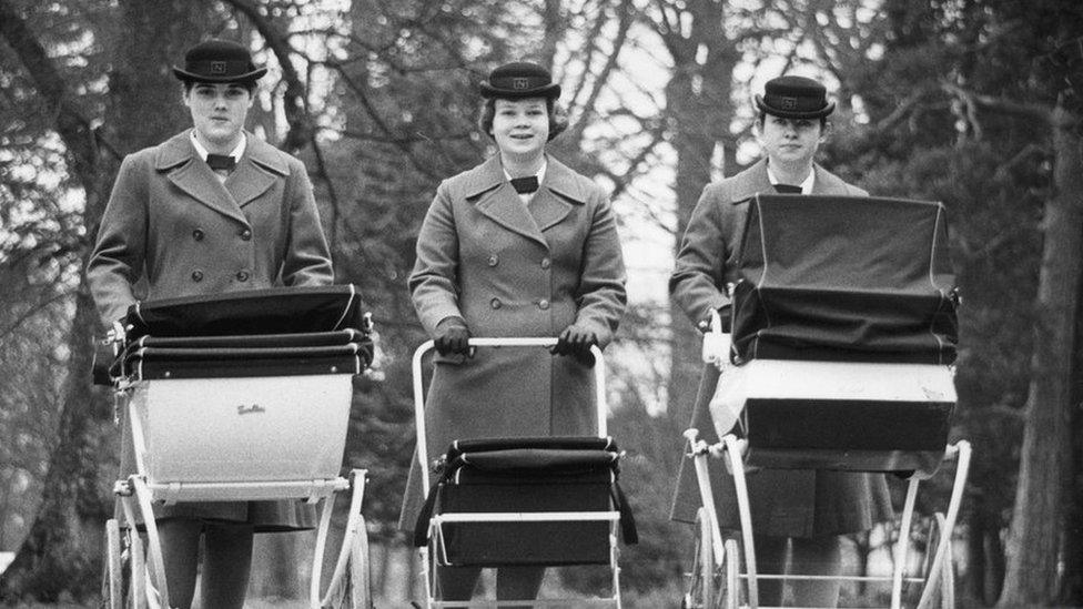 Three woman pushing prams