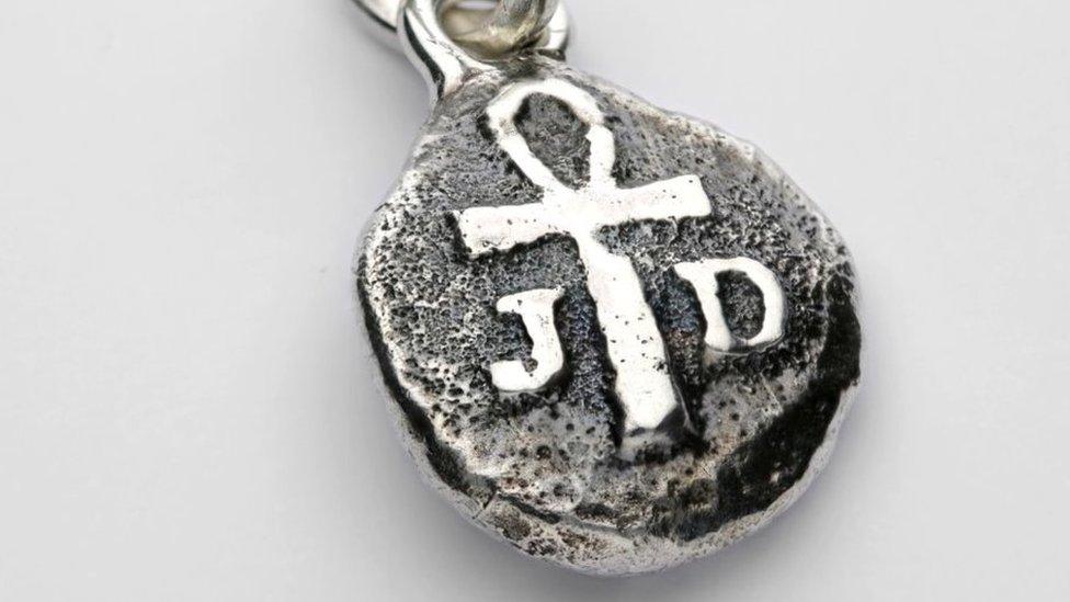 Close up of pendant showing ankh symbol and the initials JD