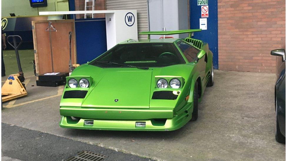 A bright green Lamborghini replica kit car with eye-lid lights