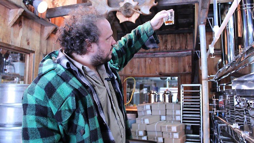 Martin Picard, the well-known chef of Au Pied de cochon famed restaurant in Montreal, looks at a test batch of his maple syrup March 9, 2012 at his sugar shack (emblematic element of lifestyle Quebec)located in Saint-Benoit de Mirabel, about sixty kilometers west of Montreal.