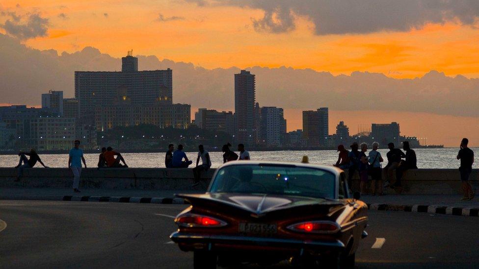 People spend the afternoon sitting on the Havana sea wall in Cuba, Wednesday, Nov. 9, 2016.