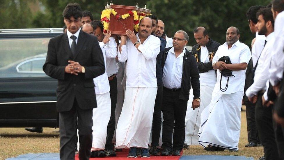 The coffin of Gurushanth Srithavarajah is carried to into marquee tents on Winn's Common