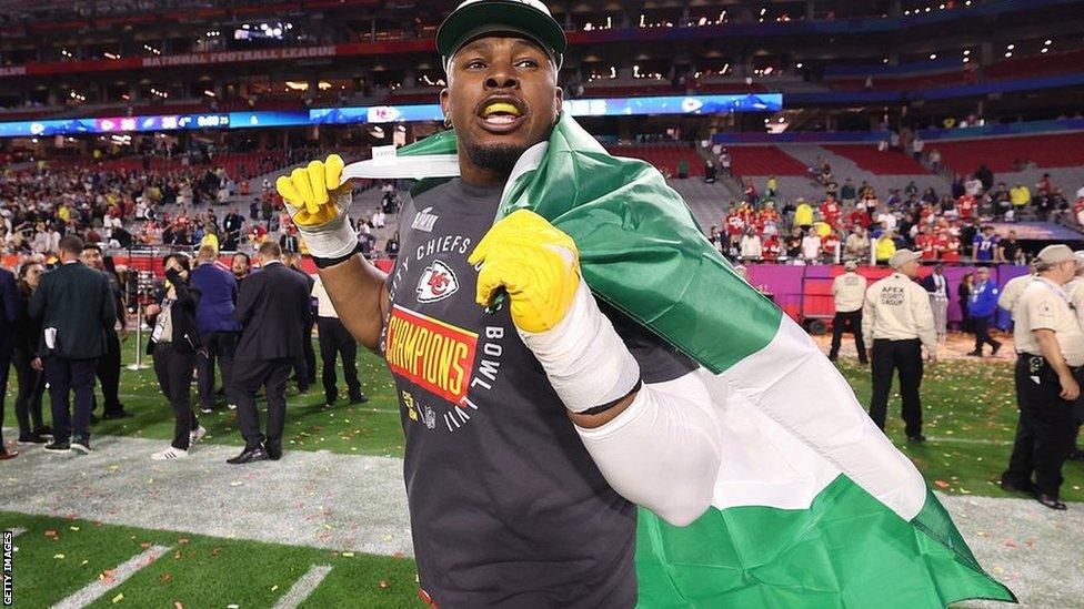 Prince Tega Wanogho celebrates Super Bowl victory with a Nigerian flag