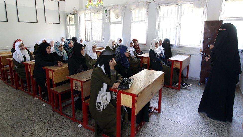 Yemeni girls listen to their teacher at a public school in Sanaa