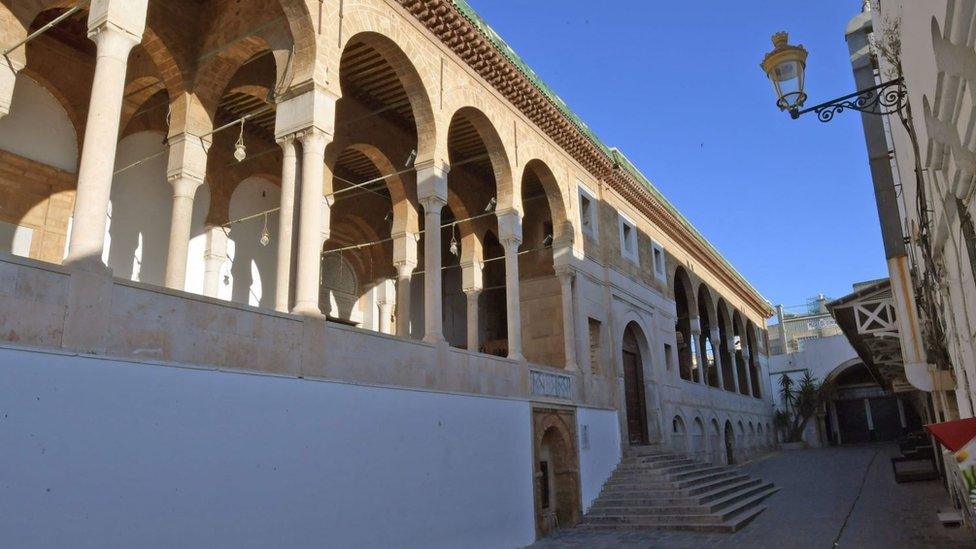 This picture taken on May 24, 2020 on the first day of Eid al-Fitr, the Muslim holiday which starts at the conclusion of the holy fasting month of Ramadan, shows a view of a deserted alley outside the Zitouna mosque in the Medina (old town) of the Tunisian capital Tunis.