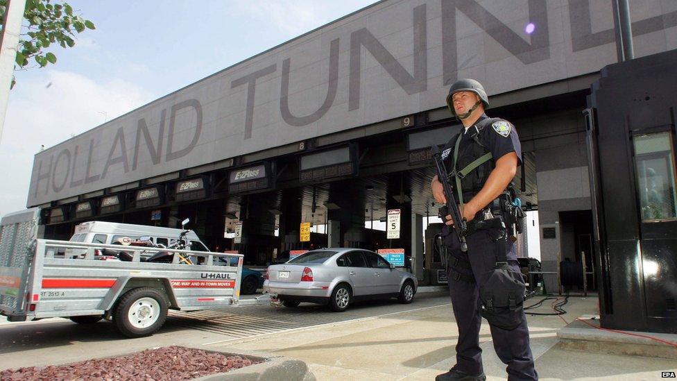 An armed policeman guarding the entrance to the Holland Tunnel