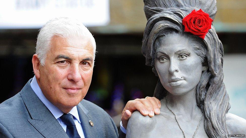 Mitch Winehouse posing with the statue of his daughter Amy which was unveiled in 2014