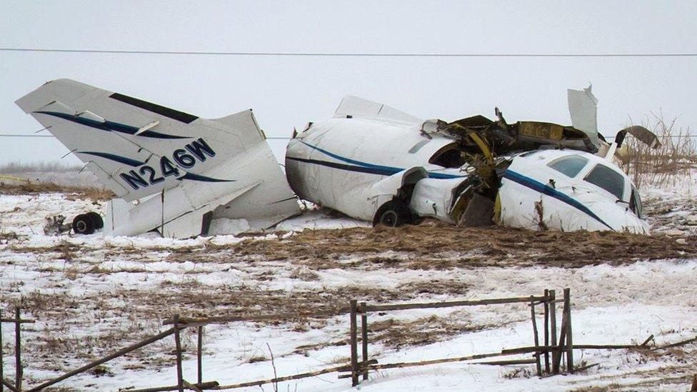 The wreckage of an airplane lies in a field Tuesday, March 29, 2016, in Havre-aux-Maison, Quebec