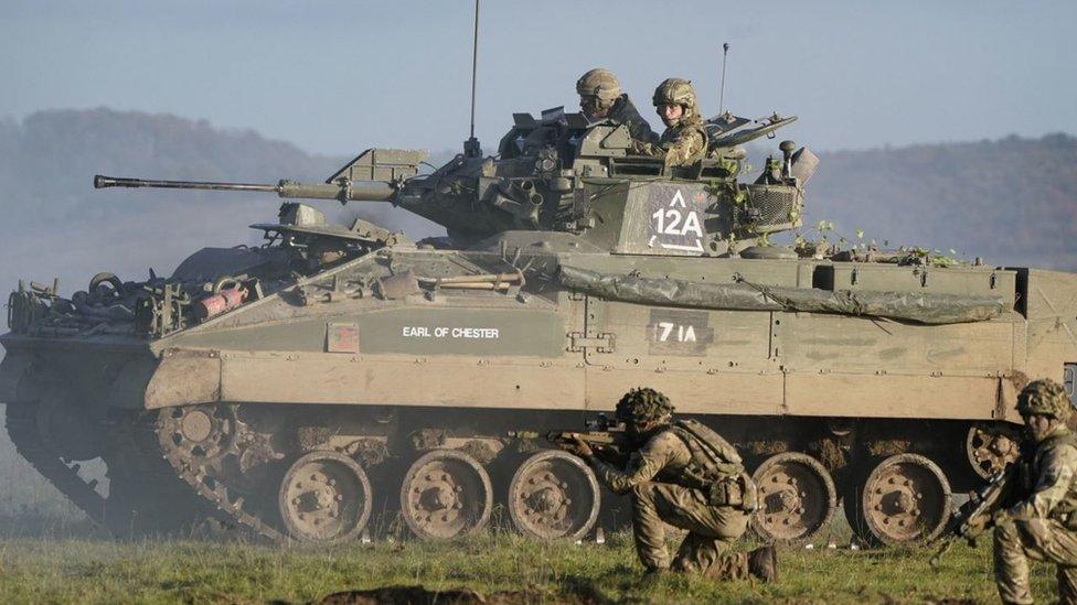 The Prince of Wales, Colonel-in-Chief, 1st Battalion Mercian Regiment (right), rides in an armoured vehicle while on a training exercise during a visit to the regiment, in the south west of the UK, for the first time following his appointment to the role by King Charles III.