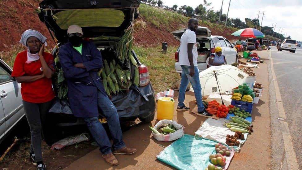 Motorists wait for customers next to their vehicles, used as alternative mobile grocery stalls along the highway, following a lockdown due to the coronavirus disease (COVID-19) outbreak, on the outskirts of Nairobi, Kenya May 25, 2020