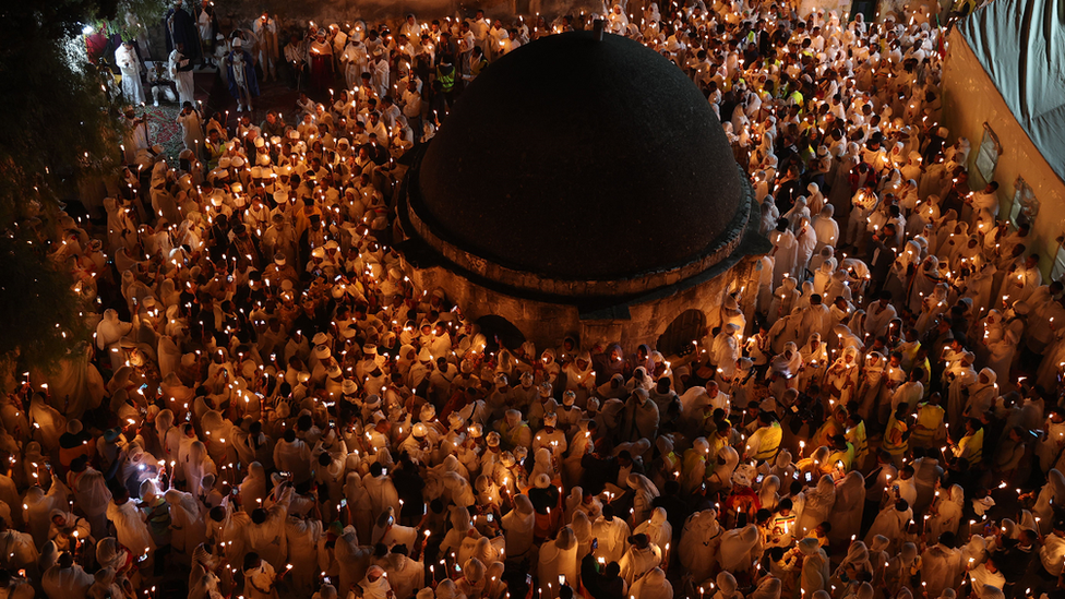 Ethiopian Orthodox Christian pilgrims hold candles during the Holy Fire ceremony