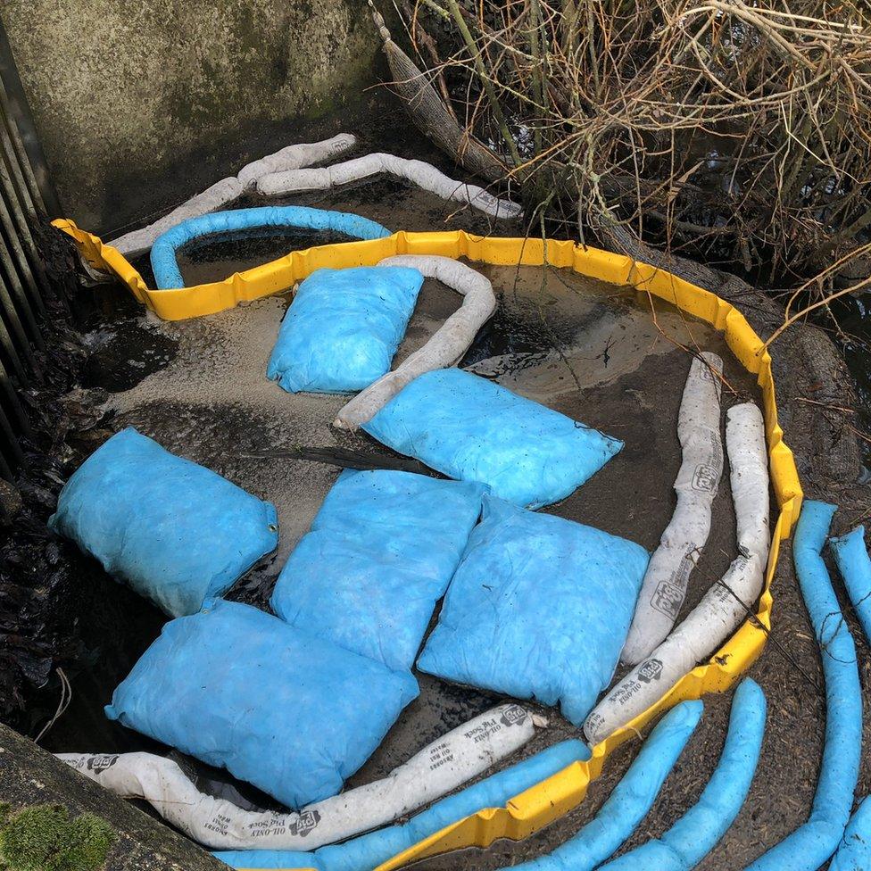 Bags to collect oil which has seeped into the River Yare, Norwich