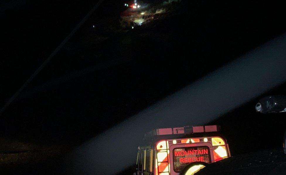 Helicopter and jeep in dark