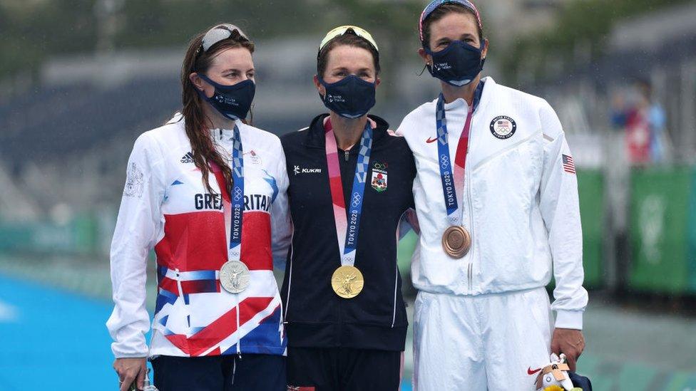 Silver medalist Georgia Taylor-Brown of Team Great Britain, gold medalist Flora Duffy of Team Bermuda and bronze medalist Katie Zaferes of Team United States pose with their medals.