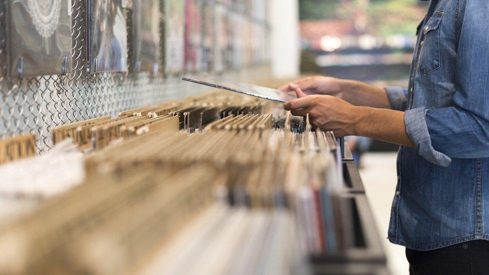 Stock image of person shopping for vinyl