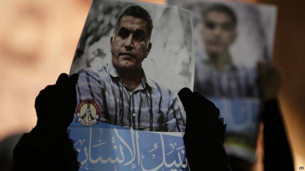 Bahraini anti-government protesters hold up images Nabeel Rajab during a solidarity protest outside his home in Bani Jamra, Bahrain (14 May 2015)