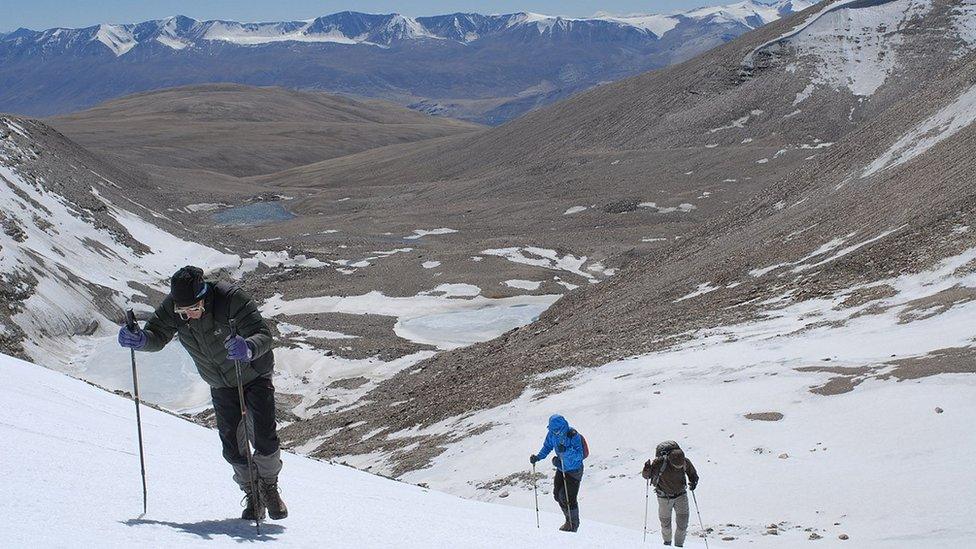 A team making their way up Mount Shukule II in India