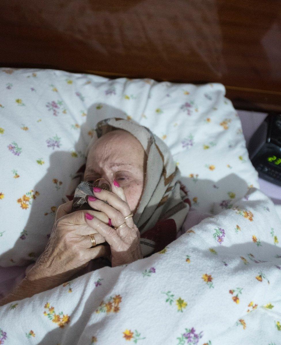 A woman kisses a figurine