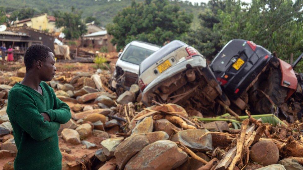 A man overlooks wreckage caused by the flooding