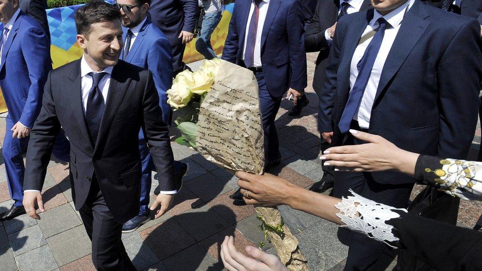 Ukraine's President Volodymyr Zelensky is greeted by supporters as he leave after the inauguration ceremony at the parliament in Kiev on May 20, 2019