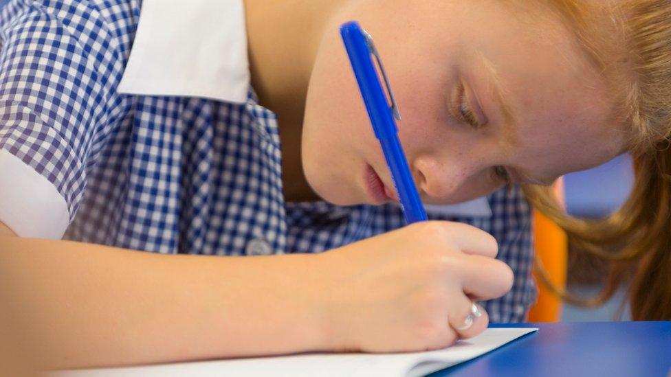 Girl writing in class