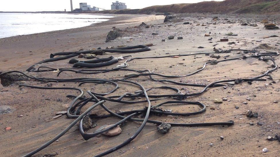 Pipes and cables on the sand at Lynemouth Beach