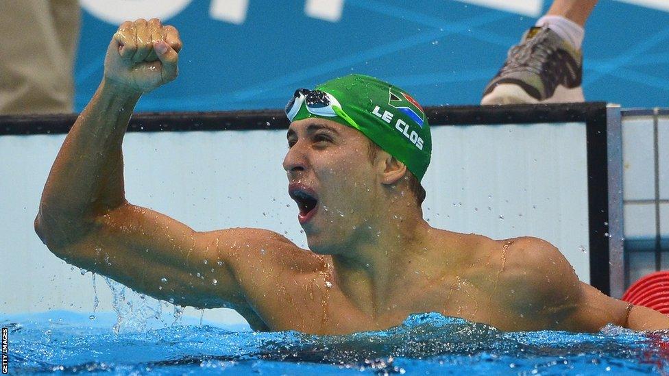 Chad Le Clos raises a fist in the air and screams in delight after winning a gold medal in the pool at the London 2012 Olympics