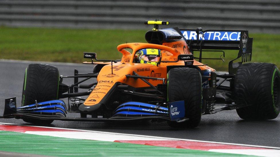 Lando Norris racing on a track