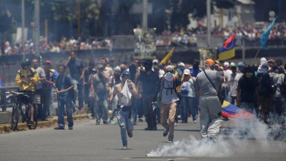 Demonstrators clash with riot police during a rally in Caracas, Venezuela